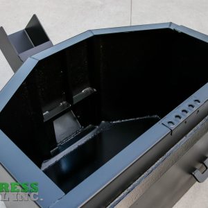 A large black Express Steel Manual Concrete Placement Bucket with angled edges sits on a concrete surface. The Express Steel Inc. logo in green and gray appears in the lower left corner.
