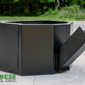 An Express Steel Manual Concrete Placement Bucket, black and hexagonal with a slanted chute, sits on concrete near a road lined with trees. The Express Steel Inc. logo is visible in the bottom left corner.