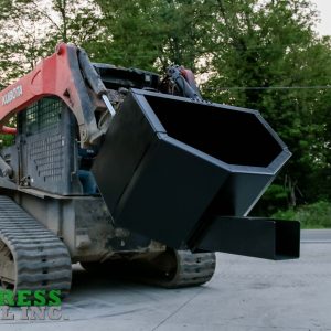 A red Kubota skid steer loader is parked on concrete near a road with trees, equipped with an Express Steel Manual Concrete Placement Bucket attachment. The Express Steel Inc. logo appears in the lower left corner.
